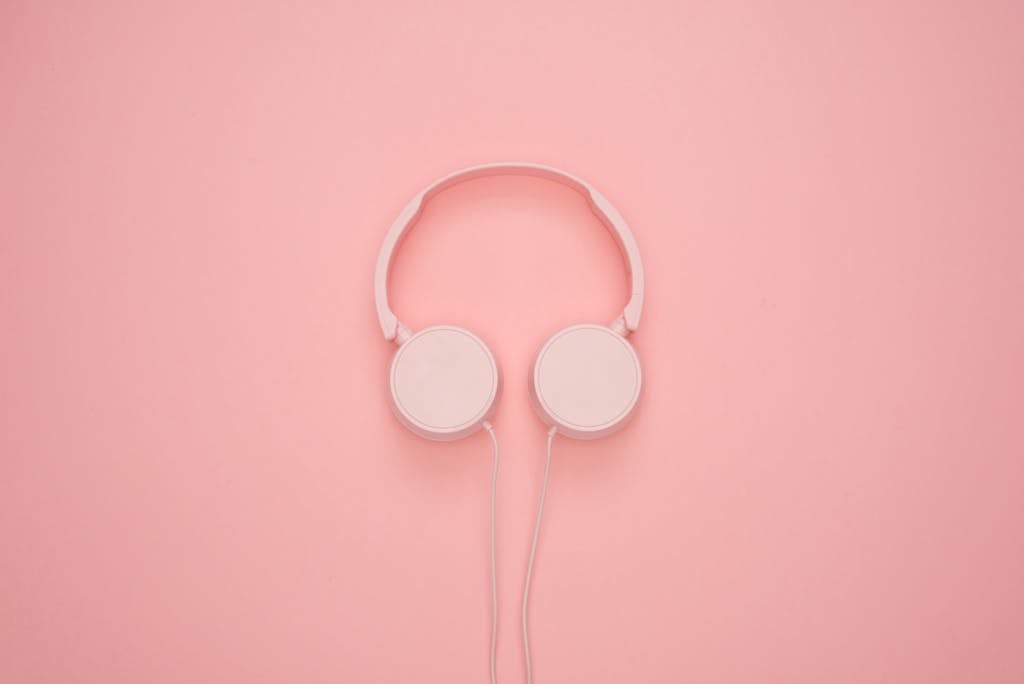 Aesthetic pink headphones on a pastel background, perfect for a modern and stylish look.